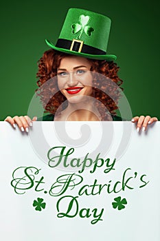 Saint Patrick`s Day. Young Oktoberfest leprechaun, wearing hat with clover on green background with banner for copy