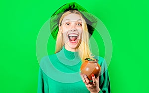 Saint Patricks Day. Happy woman in Leprechaun hat holds pot with gold. Irish Traditions. St Patrick.