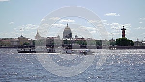 Saint-Petersburg city view at river Neva, Rostral columns, Vasilevsky island and Stock exchange, Isaac`s cathedral and
