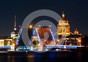 Saint Petersburg cityscape with open Palace bridge, St. Isaac`s cathedral and Admiralty building at night, Russia