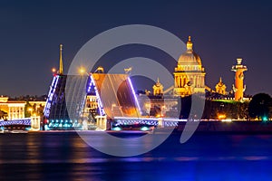 Saint Petersburg cityscape with open Palace bridge, St. Isaac`s cathedral, Admiralty building and Rostral column at night, Russia