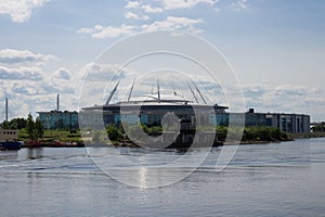 Gazprom arena. A mix of times-a view of the river, on the Bank of which stands an old house, photo