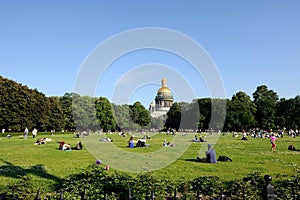 Saint Petersburg, Russia - June 25, 2016: People relaxing on the lawn next to St. Isaac Cathedral