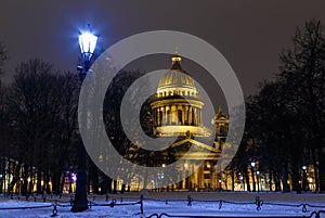 Saint Petersburg, Russia. St. Isaac`s Cathedral in lights of the evening city. View from the Palace Square in St. Petersburg.