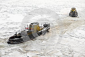 Saint Petersburg, Russia - 28.18.2022 two small vintage icebreaker ships make their way through the frozen icy sea