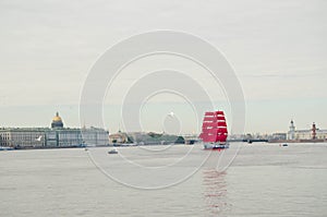 Saint Petersburg,Russia-06.02.2021 : white night,sailing ship with scarlet sails in the midst of Neva river,the dome of St. Isaac`