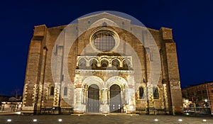 Facade of the monumental portal of the Basilica Saint Sernin illuminated at night, in Toulouse in Occitanie, France