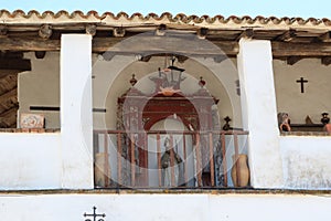 Saint on the terrace of a very old building in Pozo de la Nieve street. Aracena, Huelva, Spain photo