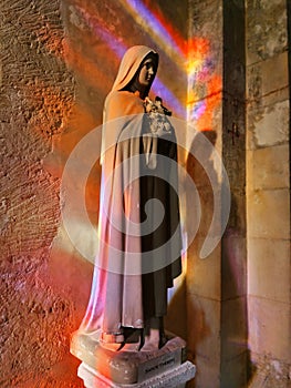 Saint therese of lisieux statue, with magnificent stained glass reflections