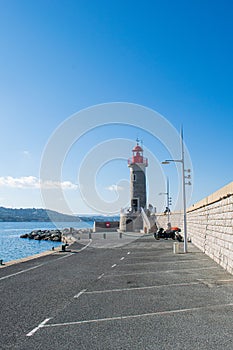 Saint Trope coast with ships in the sea with lighthouse