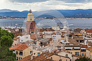 Saint Tropez, French Riviera, France. View of the old town with church tower, sea and mountains.