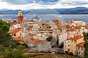 Saint Tropez, French Riviera, France. View of the old town with church tower, sea and mountains.