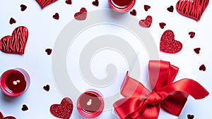 Saint Valentin background: red love hearts, romantic gift box, candle on white table. Romantic message template with copy space.