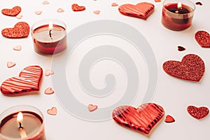 Saint Valentine day: red love hearts, romantic gift box, candle on white background. Romantic message template with copy space