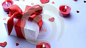 Saint Valentine day: red love hearts, romantic gift box, candle on white background. Romantic message template with copy space