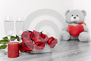 Saint Valentine`s day bouquet of roses, candle and teddybear