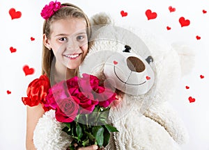 Saint Valentine`s day. Pretty girl with red dress, red roses bucket and heart