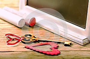 Saint Valentines decoration: heart and key, black board and chalk