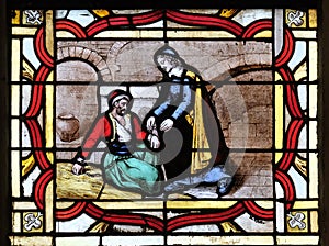 Saint Vincent de Paul helps a prisoner, stained glass window from Saint Germain-l`Auxerrois church in Paris