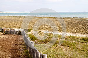 Saint Vincent sur Jard beach wooden fence along pedestrian path in Vendee France