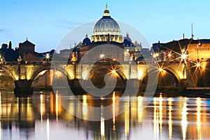 The SaintAngel bridge and St. Peter`s Basilica , Rome, Italy .