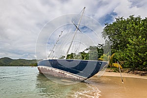 Sainte-Anne, Martinique, FWI - Abandoned beached sailboat in Pointe Marin beach