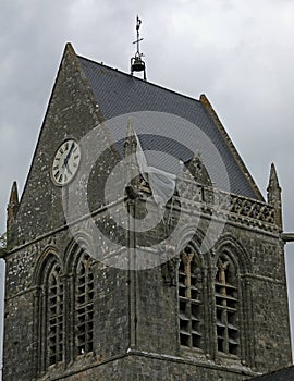 Sainte-Mere-Eglise, FRA, France - August 21, 2022: DDAY Memorial with us Paratrooper on bell tower