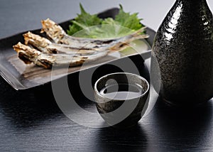 Sake and grilled urume sardines placed behind it