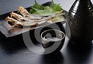 Sake and grilled urume sardines placed behind it