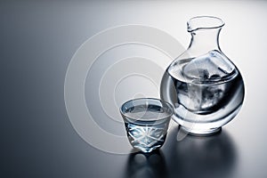 Sake poured into a faceted glass against a black background