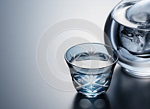 Sake poured into a faceted glass against a black background