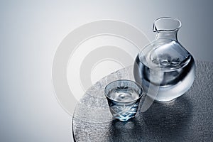 Sake poured into a faceted glass against a black background