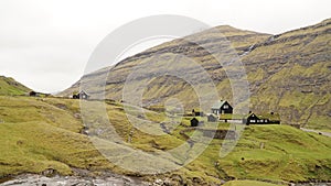 Saksun Village and beach in green landscape on the Faroe Islands in Denmark.