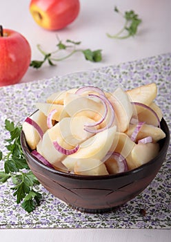 Salad of apples and red onions in bowl