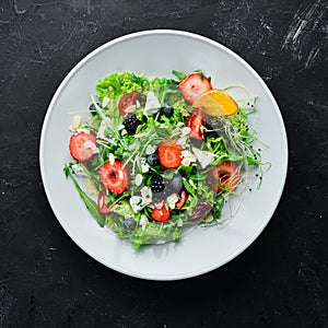 Salad. Salad of arugula, blue cheese, strawberries and blueberries.