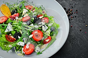 Salad. Salad of arugula, blue cheese, strawberries and blueberries.