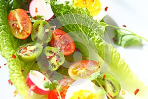 Salad with baby kiwis and radishes