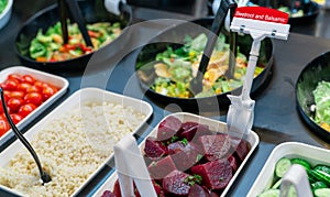 Salad bar buffet at restaurant. Fresh salad bar buffet for lunch or dinner. Healthy food. Beetroot and balsamic in bowl on counter