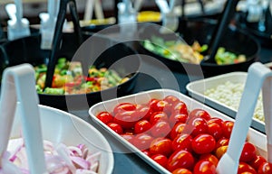 Salad bar buffet at restaurant. Fresh salad bar buffet for lunch or dinner. Healthy food. Selective focus on red tomatoes in white