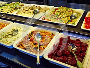 Salad bar with different fresh vegetables and other dishes