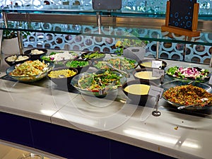 Salad bar with fresh organic vegetables in the restaurant