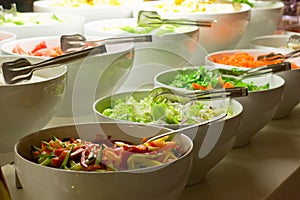 Salad bar. Fresh vegetables in white bowls