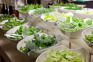 Salad bar. Fresh vegetables in white bowls