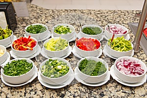 Salad bar with various sliced fresh vegetables