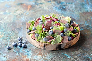 Salad with beef jerky and fresh blueberries