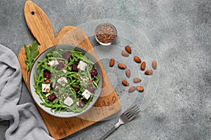 Salad with beets, arugula and cheese background. Diet healthy salad. Gray concrete background. View from above