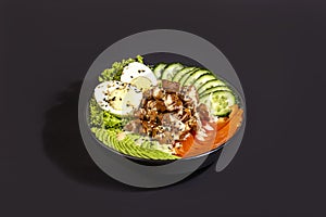 Salad bowl with beef, rice, tomatoes, cucumbers and avocado. Boiled egg.