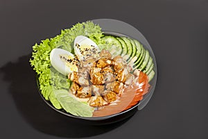 Salad bowl with chicken breast, rice, tomatoes, cucumbers and avocado Boiled egg