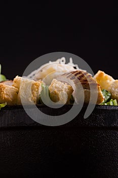 A salad bowl with lettuce bread cheese and grilled chicken photo