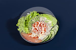 Salad bowl with salmon rice, tomatoes, cucumbers and avocado. Boiled egg.